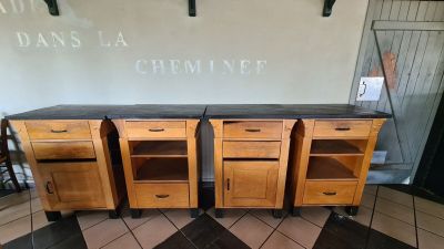 three wooden cabinets that are on wheels in front of a wall