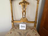a gold chair with a number on it in front of a door