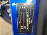 a close up of a blue motorcycle with a sticker on it ' s side