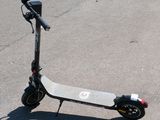 a scooter that is sitting on the pavement