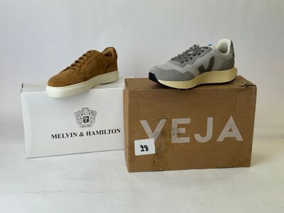 grey and white sneakers in a box on a white surface