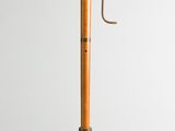 an old fashioned wooden cane with a metal handle on a white background