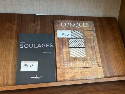 two books are sitting on a table next to each other