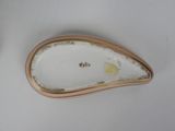 a white plate with a gold edge on a white table