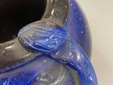 a blue vase with a fish design on it