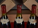 three bottles of wine sitting on a table next to each other