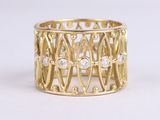 a close up of a gold ring with diamonds on a white background