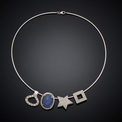 a necklace with a blue stone and diamonds on a black background