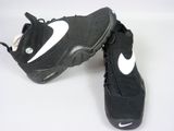 a pair of black and white sneakers on a white surface