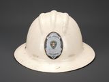 a white hard hat with a police badge on it
