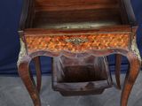 a small wooden table with a drawer on top of it