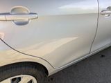 a silver car parked in a parking lot next to a parking meter