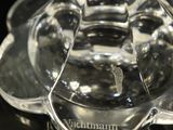 close up of a glass of wine on a black surface