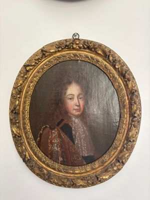 two framed portraits of a man and a woman on a wall
