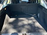 the back of a car with the trunk open and the seats folded down