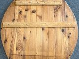 an image of a round wooden table with a shelf on top of it