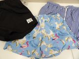two pairs of shorts and a hat on a table