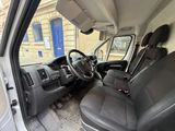 the interior of a white van with black leather seats and a steering wheel