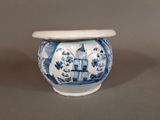 a blue and white vase with a bird on it
