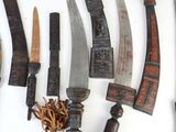 many different types of knives on a white surface