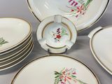 many plates and cups that are sitting on a table
