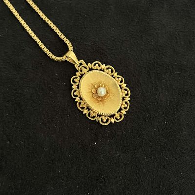 a close up of a necklace on a black surface