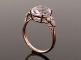 a close up view of a ring with a large white topaz stone in the center