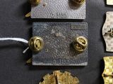 a lot of gold and silver badges on a black surface