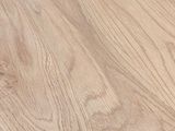 a close up of a wooden table with a black chair in the background