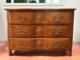 a wooden dresser with many drawers on it