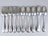 six spoons and six forks on a white table