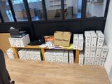 many boxes of books on a wooden shelf in a room