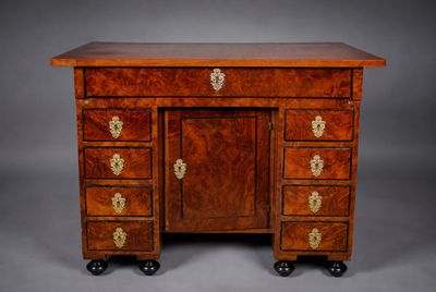 an antique mahogany desk with four drawers and brass handles