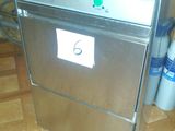 a silver dishwasher sitting on top of a wooden floor