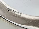 a close up of a silver plate on a table