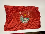 red flag with a star on it on a white table