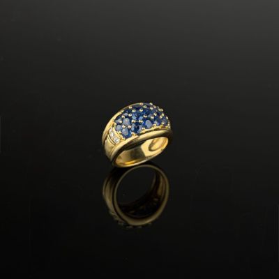 a gold ring with blue sapphires and diamonds