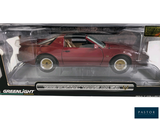a red toy car in a box on a white background