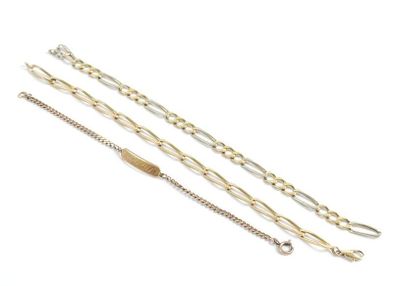 three gold and silver chain bracelets on a white background