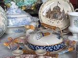 many plates and bowls on a table with pictures on them