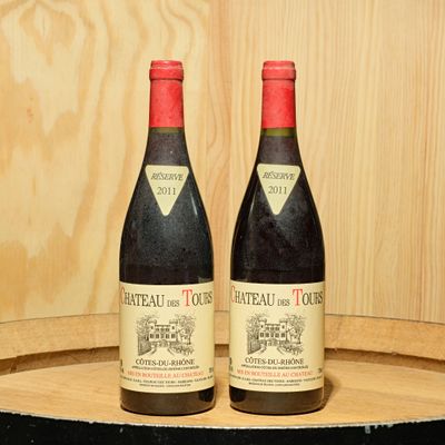 two bottles of wine sitting on top of a barrel