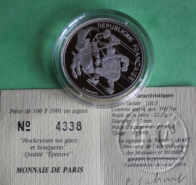 the silver coin is on top of a piece of paper on a green surface