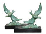 pair of green birds on black bases on a white background