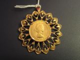 an image of a gold coin is hanging from a string