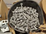 a bucket full of nuts and bolts sitting on a table