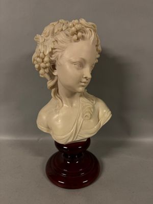 bust of a woman with braid hair on a wooden base