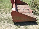 a rusted out tractor bed in the middle of a field
