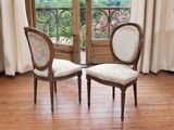 two chairs that are sitting in front of a window