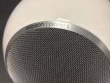 an image of a white speaker sitting on top of a table