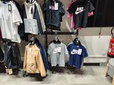 a lot of clothes hanging on a wall in a store